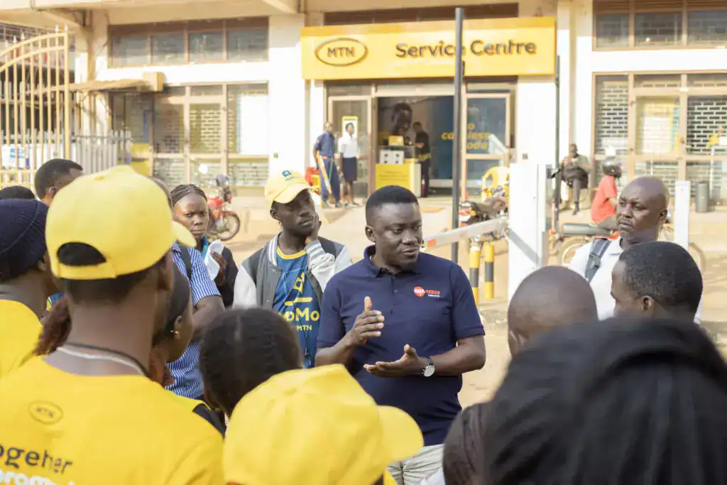 Simba Telecom customer service team engaging with customers outside an MTN Service Centre for mobile and internet support.